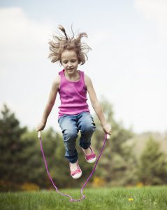 little girl skipping
