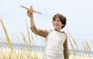little boy playing with toy airplane